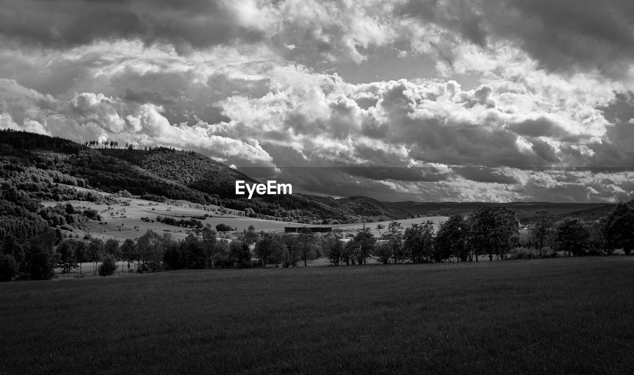 SCENIC VIEW OF FIELD AND MOUNTAINS AGAINST SKY