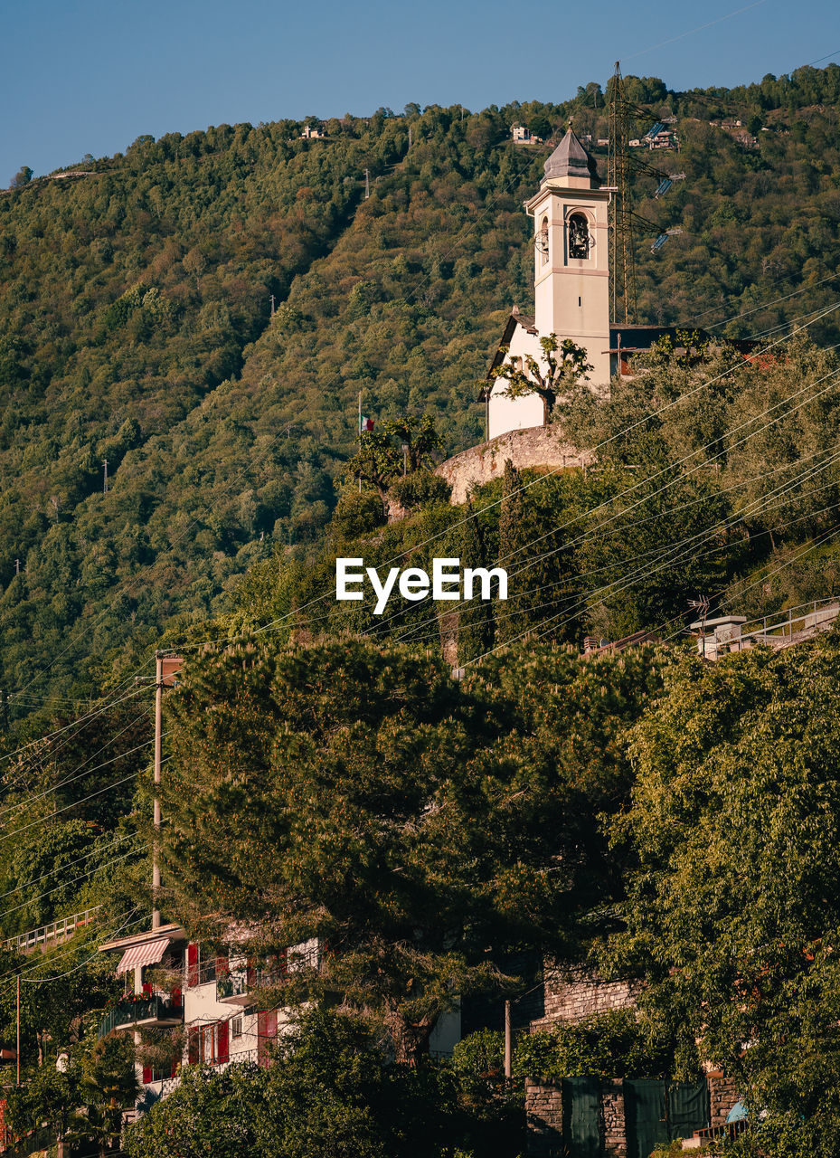 Church surrounded by vegetation in the mountains of lake como