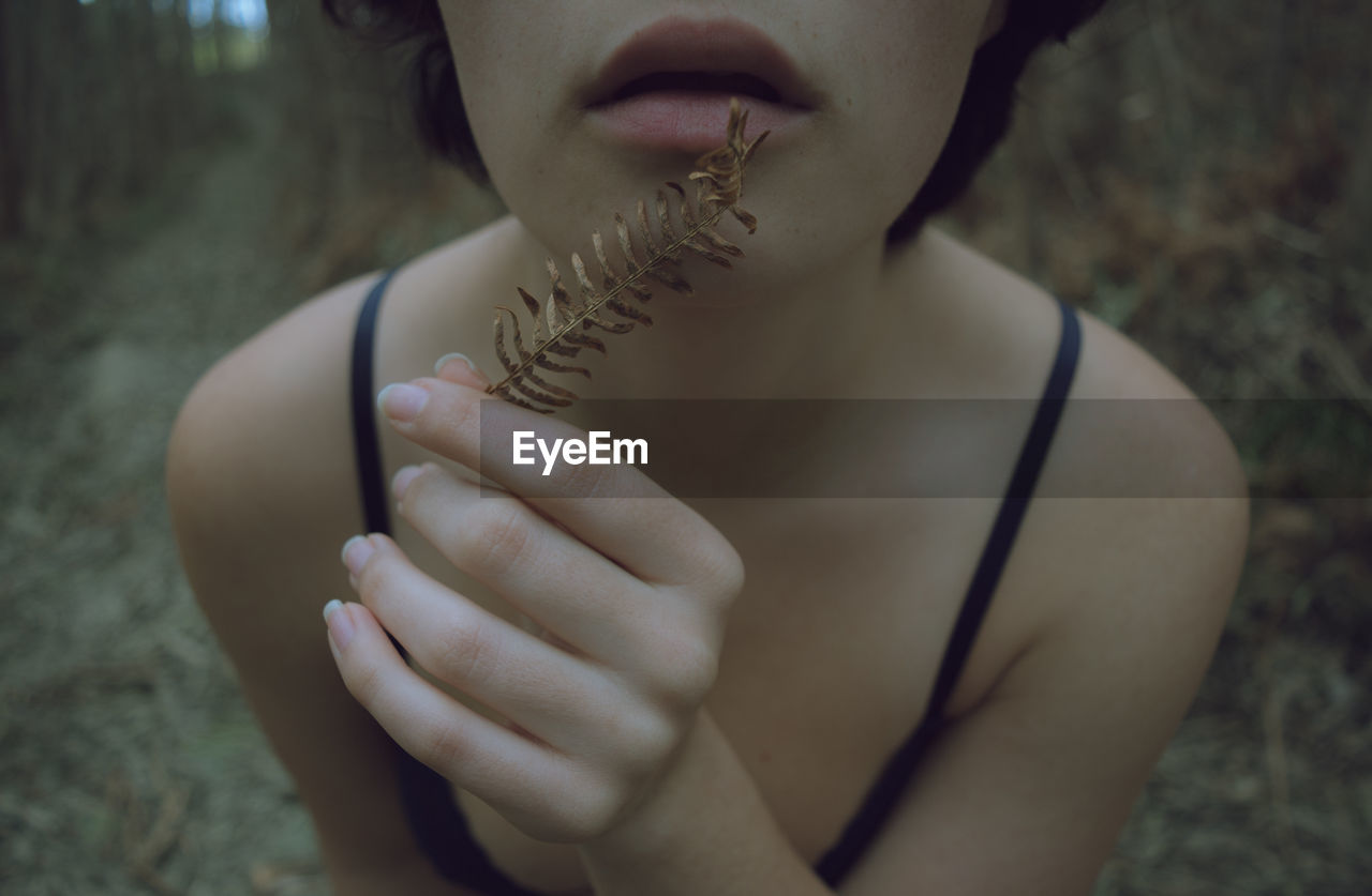 Midsection of woman holding dry leaves