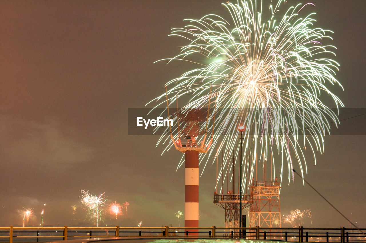 Low angle view of firework display at night