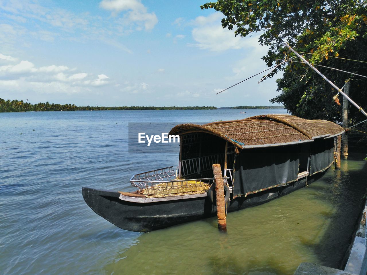 Boat on calm lake against sky