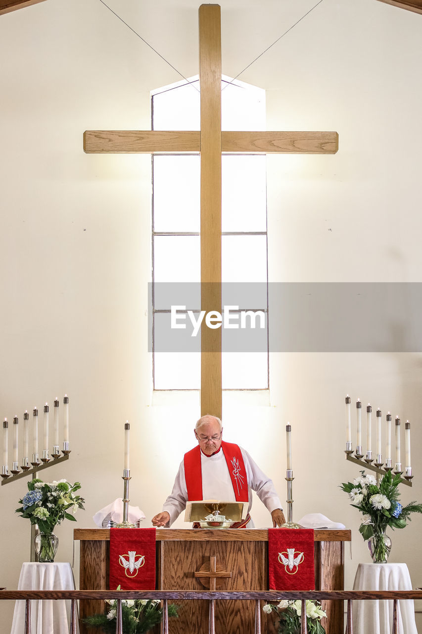 Priest standing in church