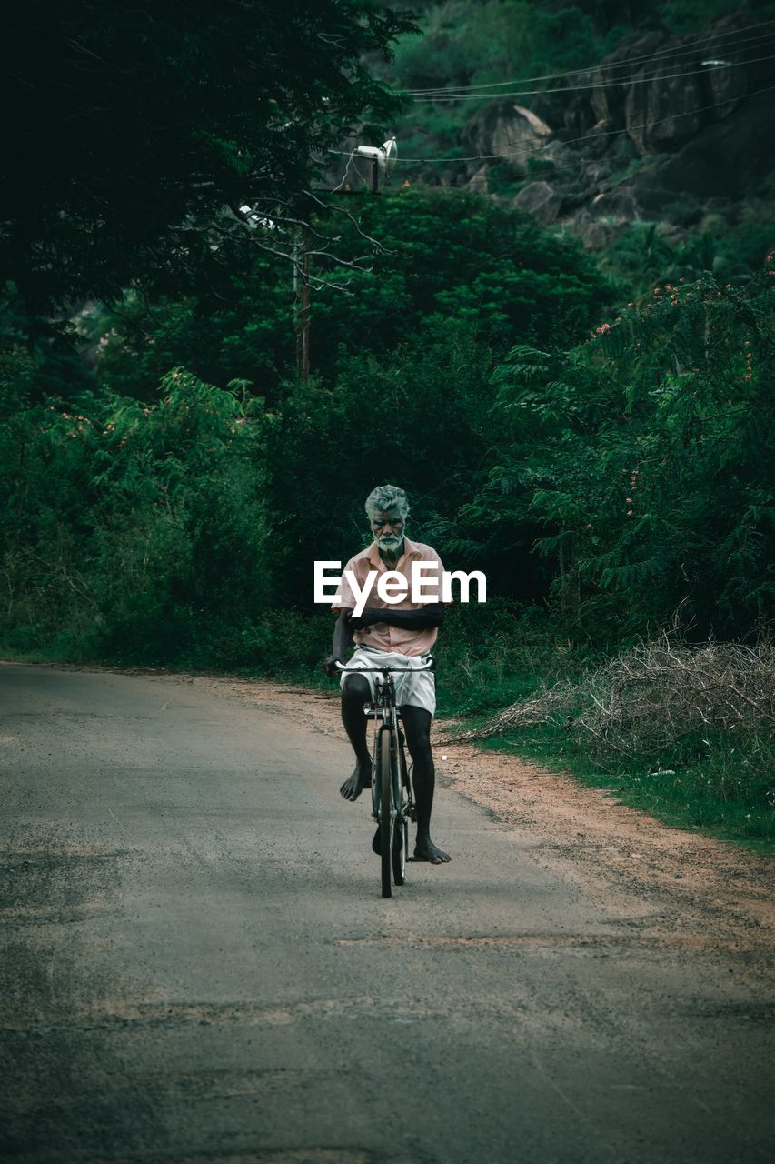 Man riding bicycle on road