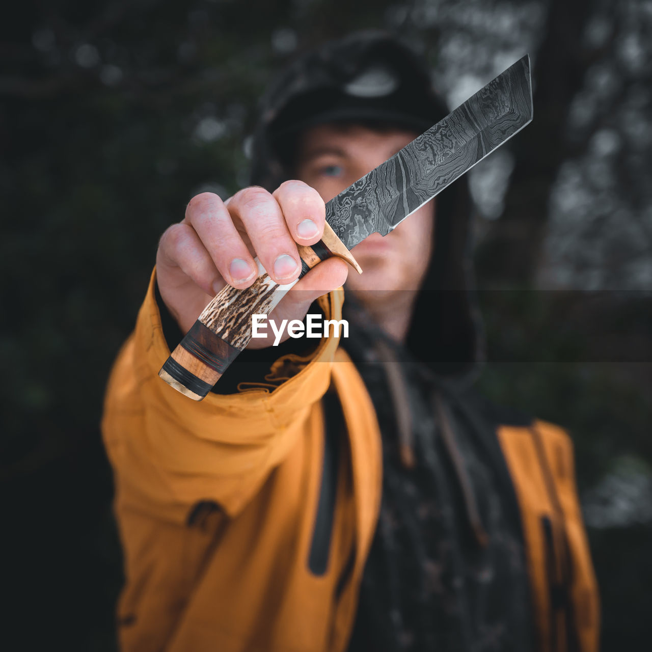 Midsection of man holding knife