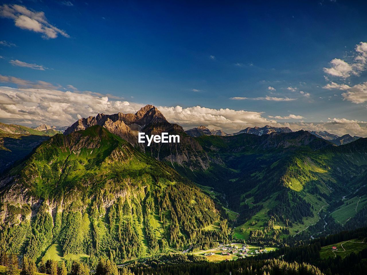 Scenic view of mountains against blue sky