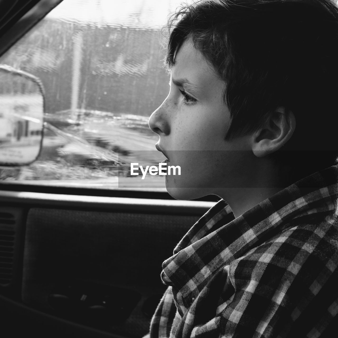 Close-up of thoughtful boy in car