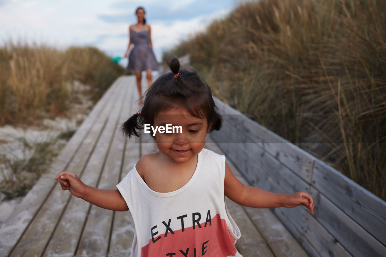 Smiling girl on boardwalk