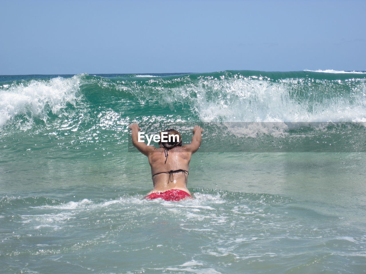 Rear view of woman diving in sea