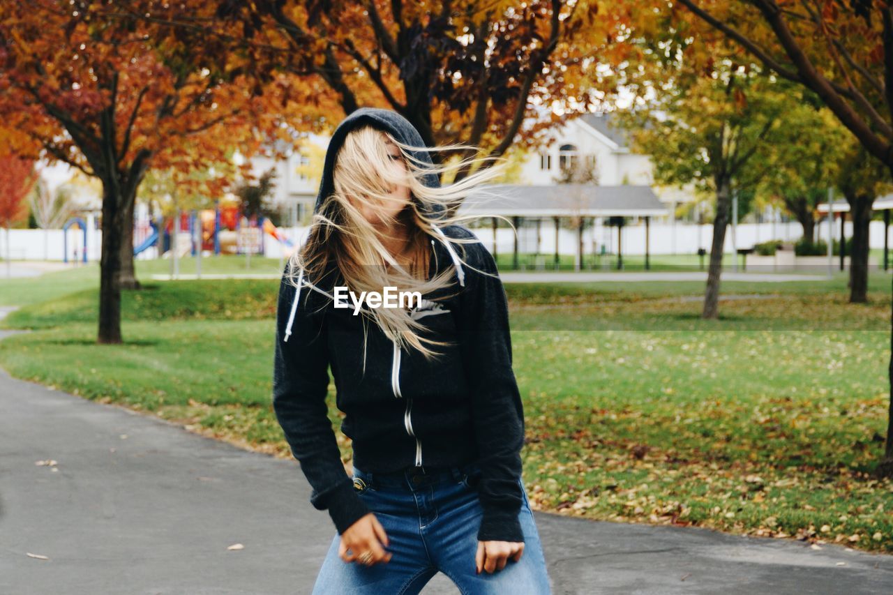 Rear view of woman standing in park