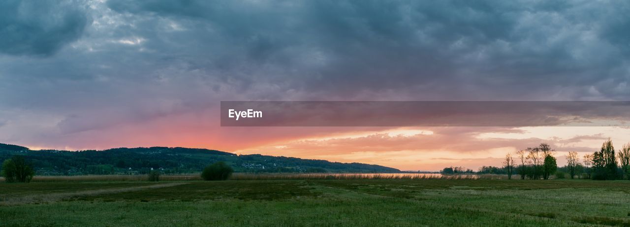 SCENIC VIEW OF LAND AGAINST SKY DURING SUNSET