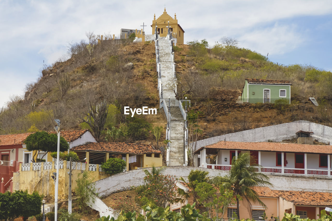 Houses against church on top of mountain