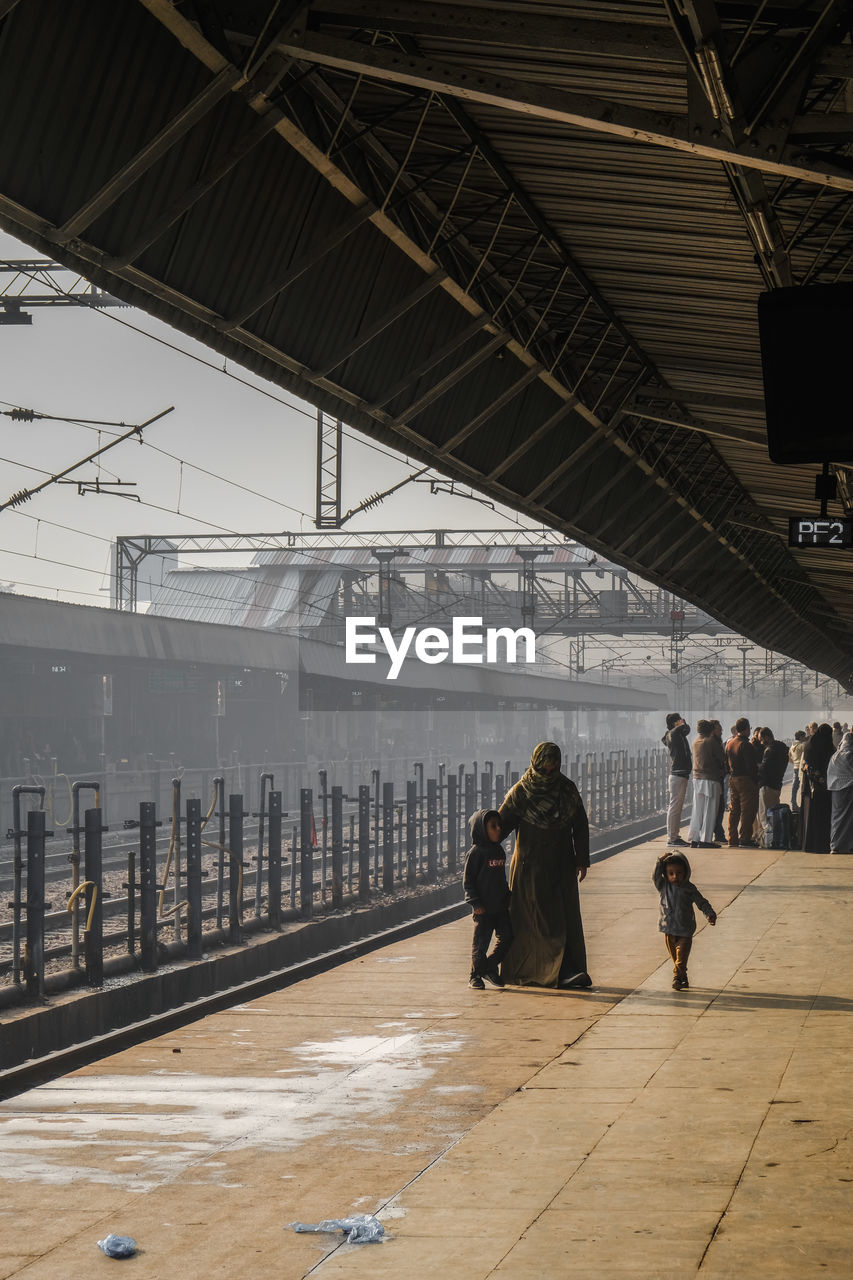 PEOPLE WAITING AT RAILROAD STATION