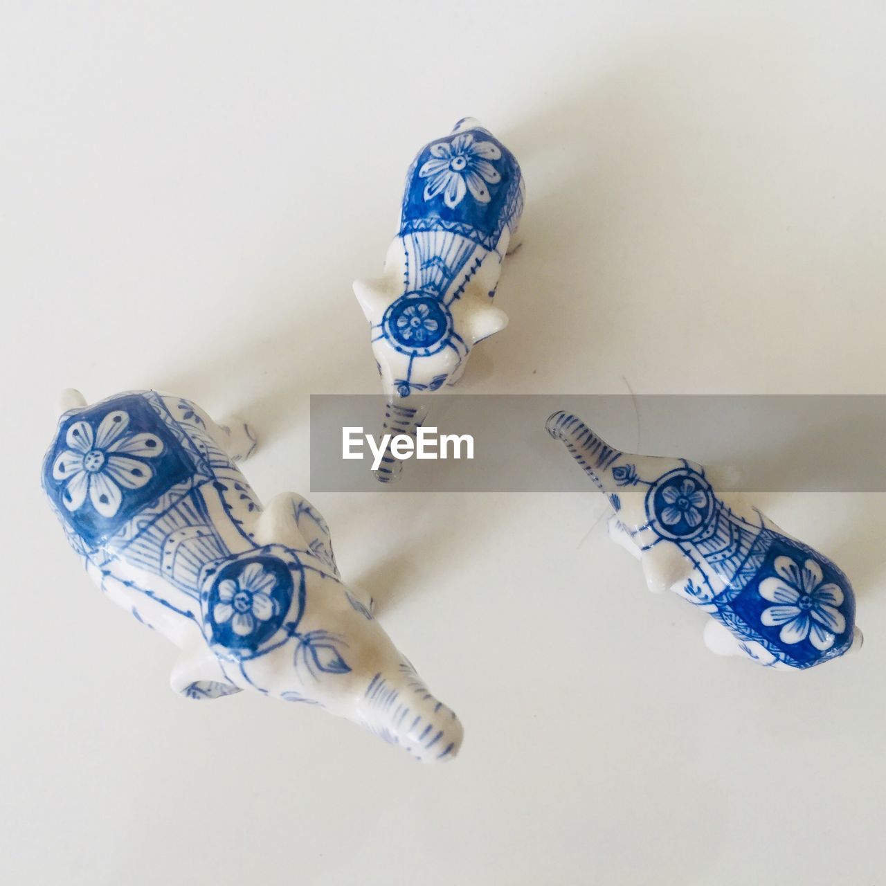 Close-up of elephant toys against white background