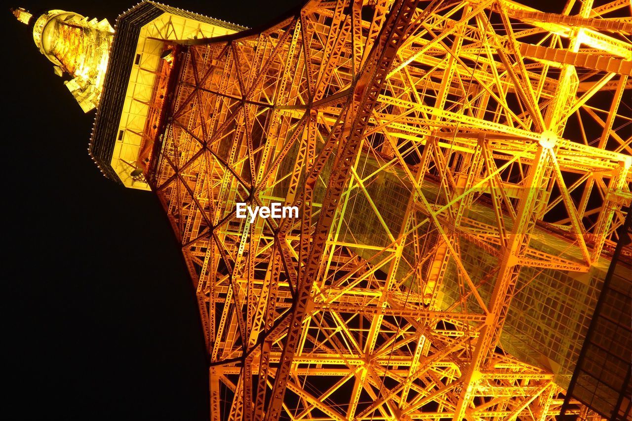 Low angle view of illuminated tokyo tower against clear sky at night