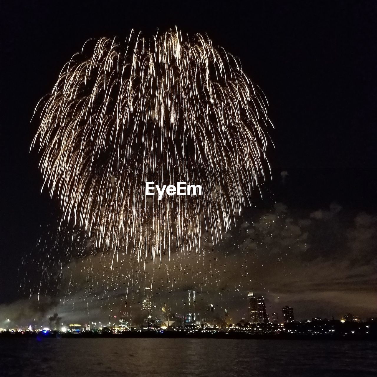 Low angle view of firework display at night