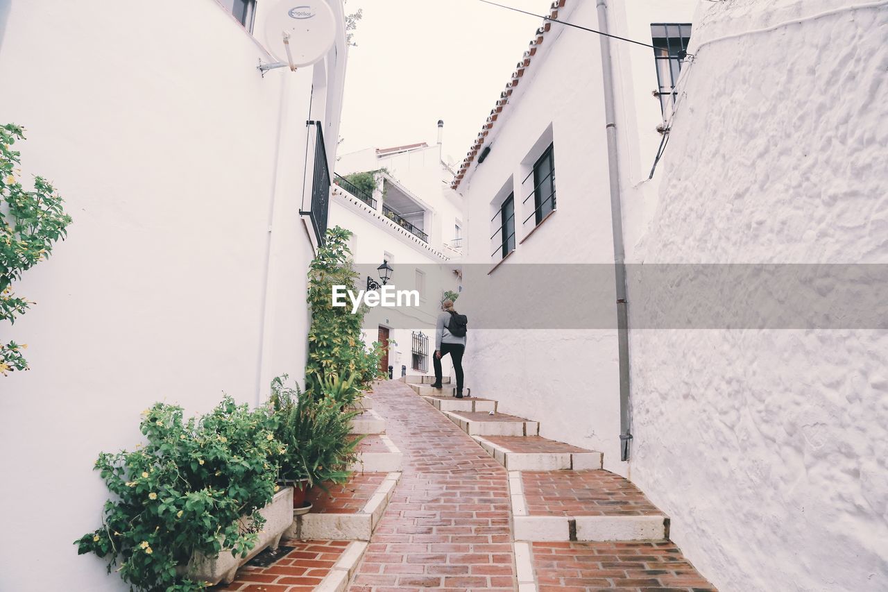 NARROW ALLEY AMIDST HOUSES