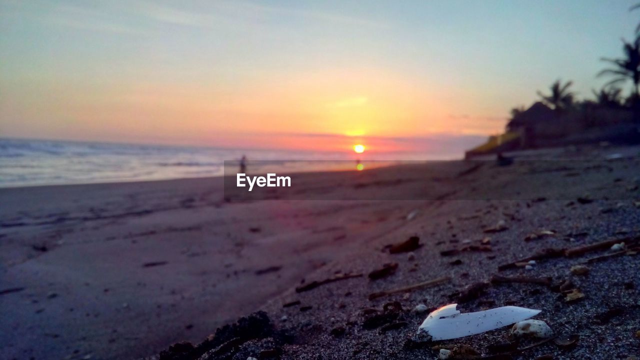 VIEW OF BEACH AGAINST SKY DURING SUNSET