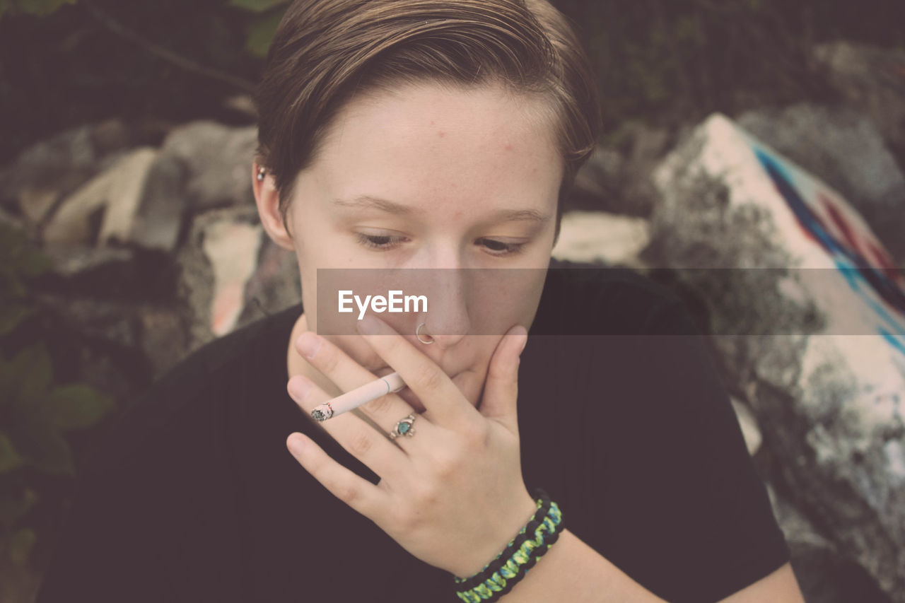 Close-up portrait of young woman smoking