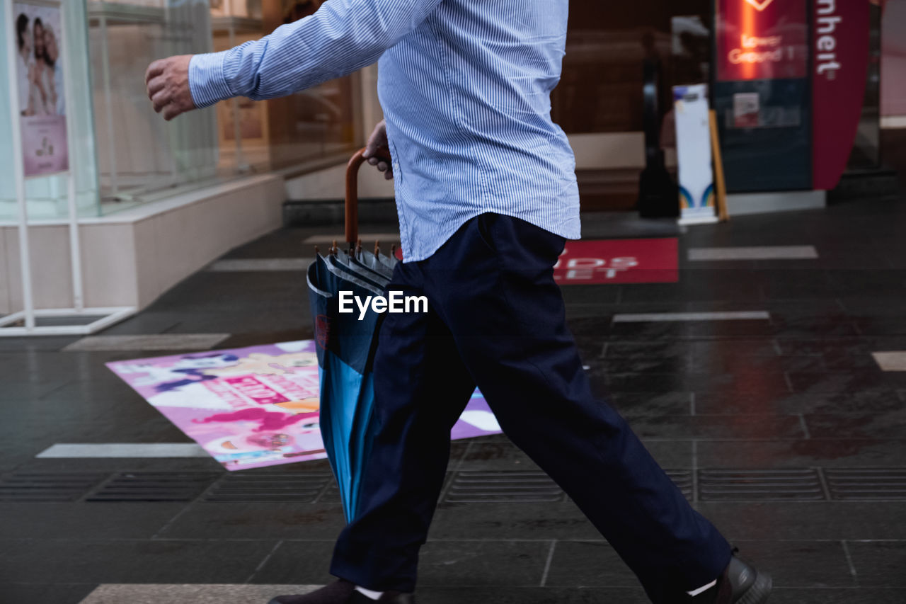 LOW SECTION OF MAN WALKING ON STREET