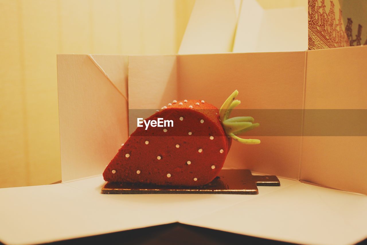 Strawberry shaped cake on table