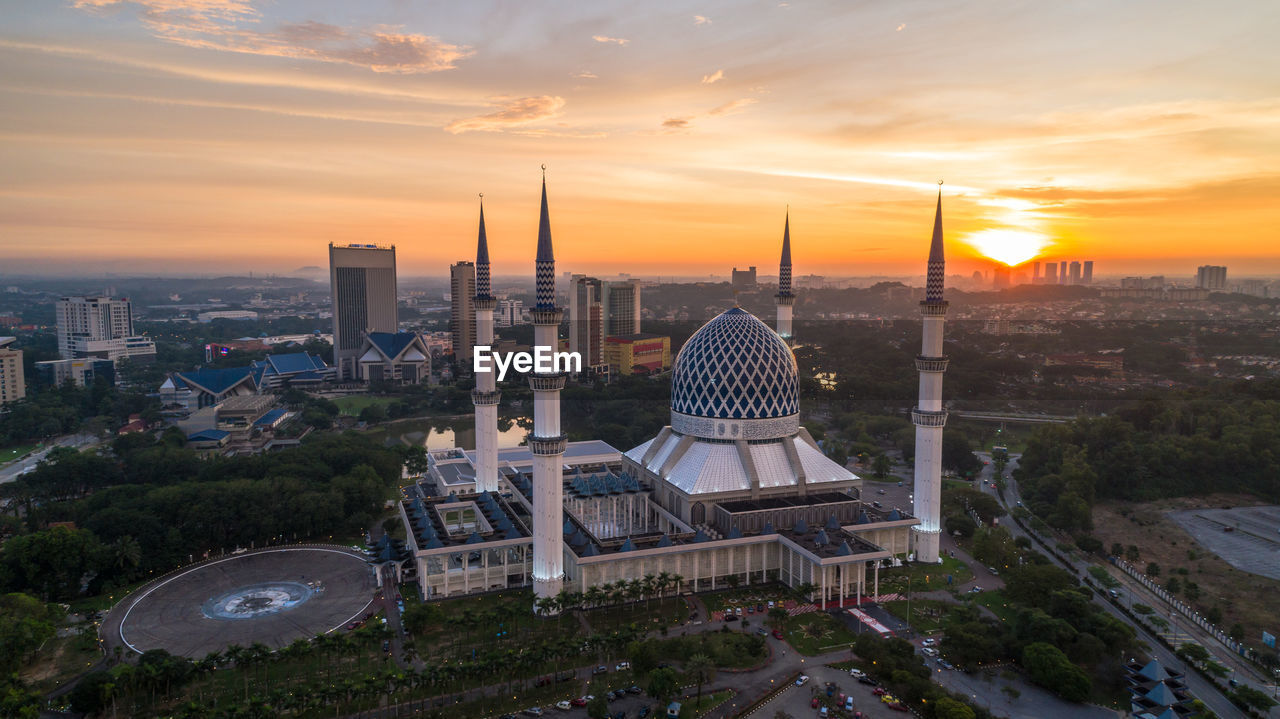 BUILDINGS AGAINST SKY DURING SUNSET