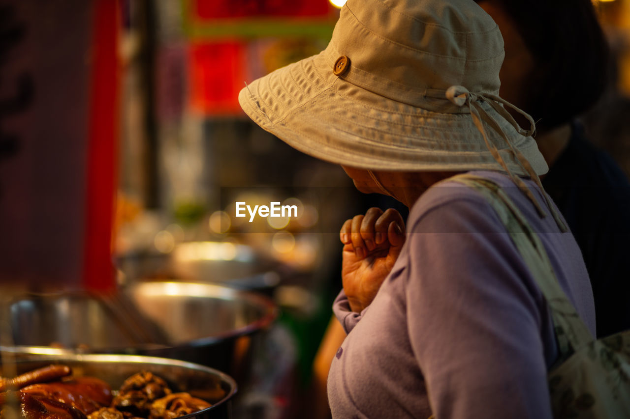 Woman looking at food in market