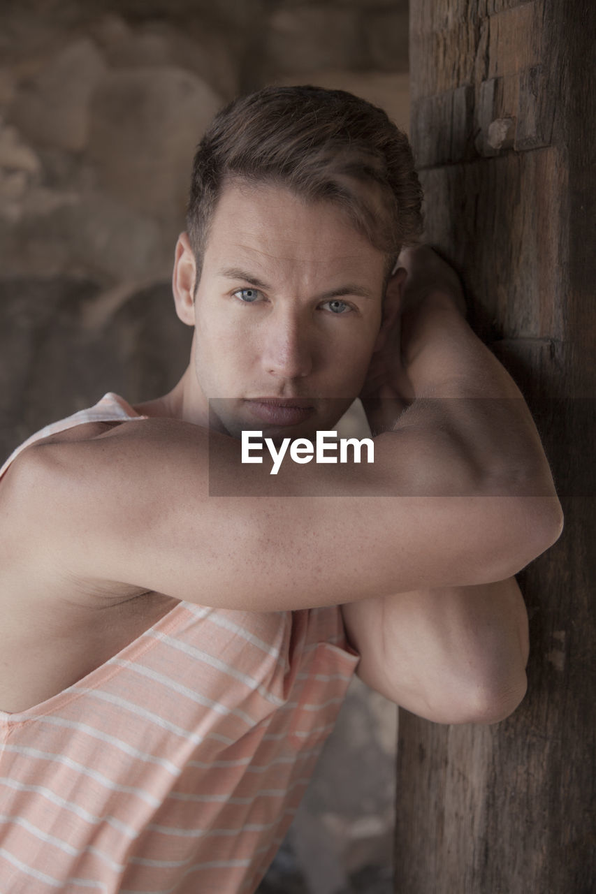 Portrait of shirtless man standing outdoors