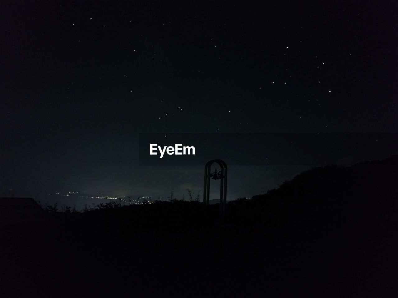 Low angle view of silhouette mountain against sky at night