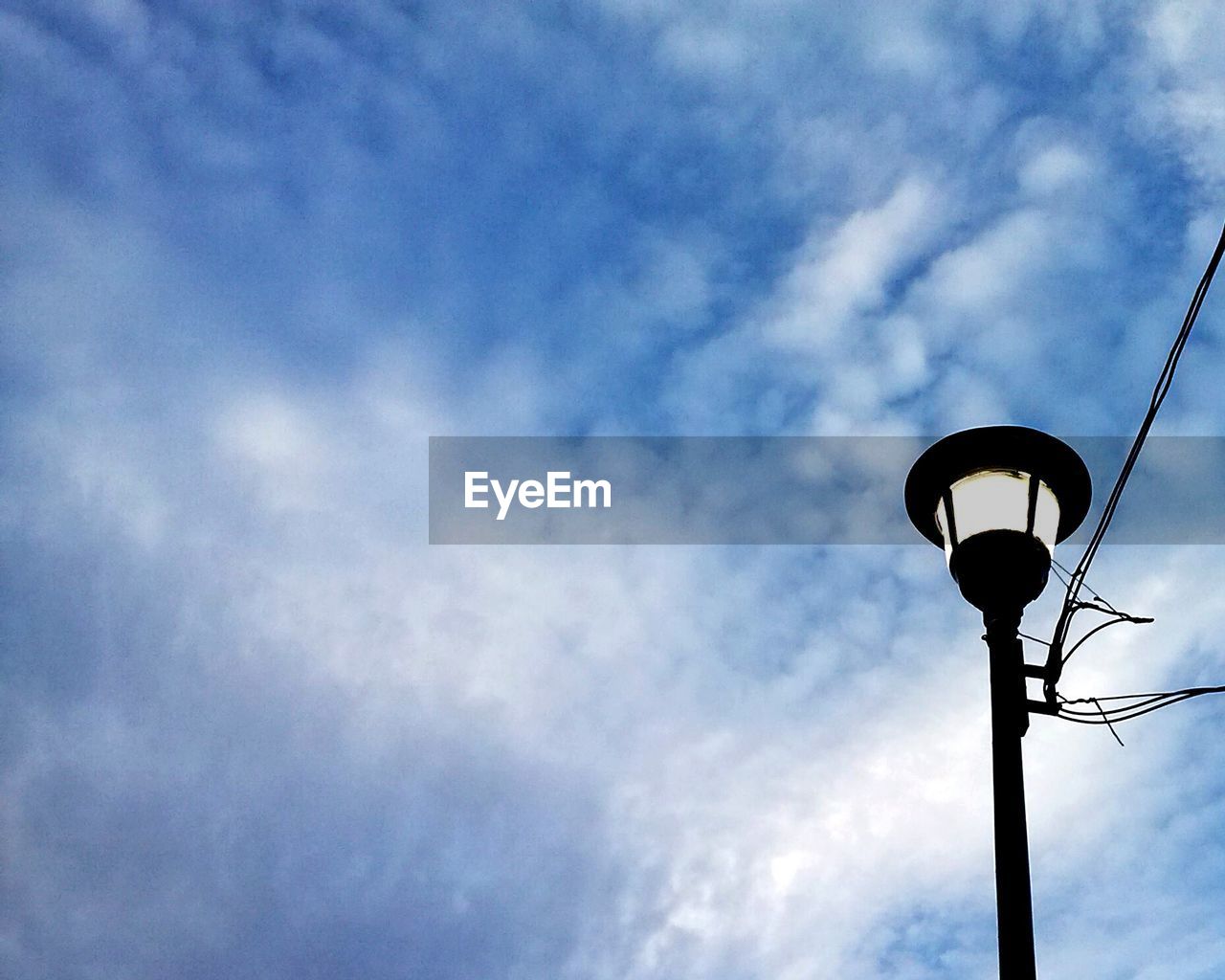 LOW ANGLE VIEW OF COMMUNICATIONS TOWER AGAINST SKY