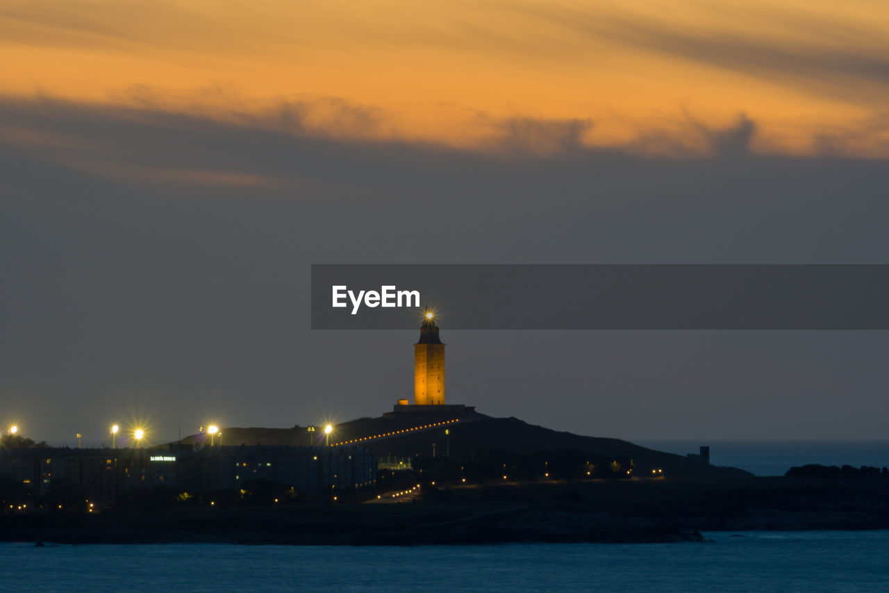 Illuminated city at night, tower of hercules at night, a coruña skyline at night