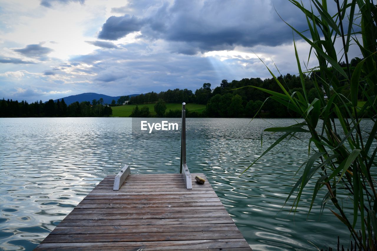 Pier over lake against sky