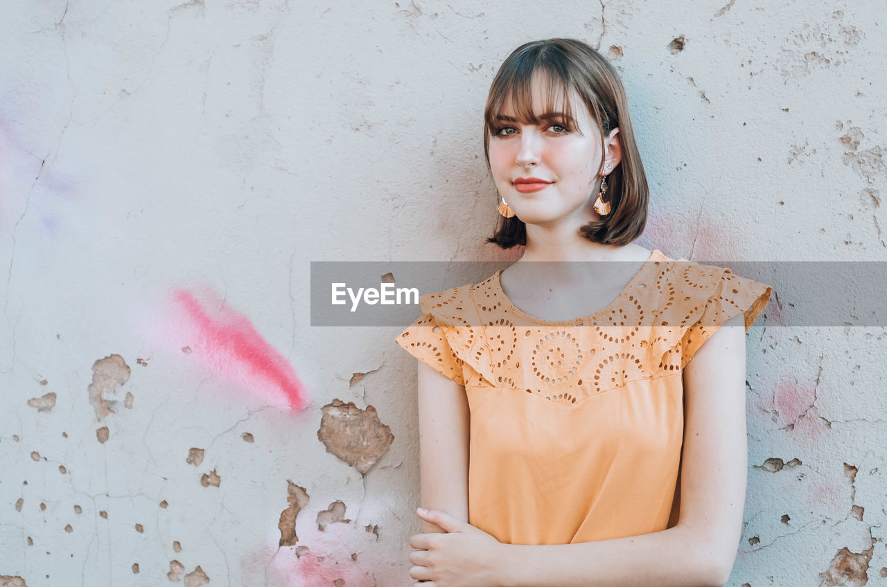 Portrait beautiful of woman standing against wall