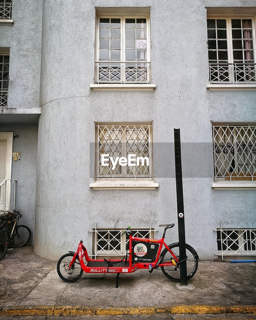 BICYCLE PARKED BY WINDOW