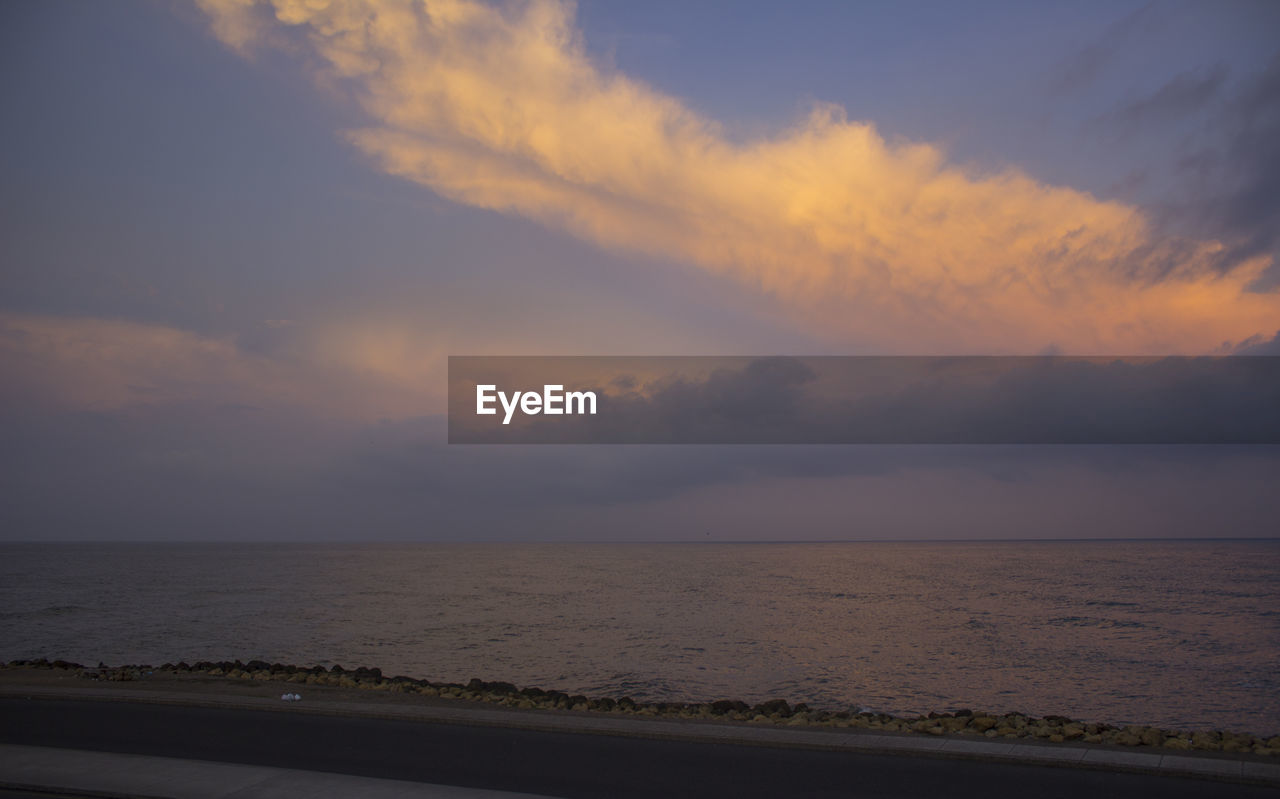 Scenic view of sea against sky at sunset