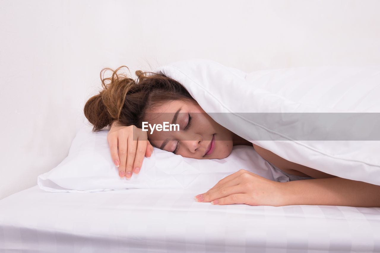 Young woman sleeping on bed