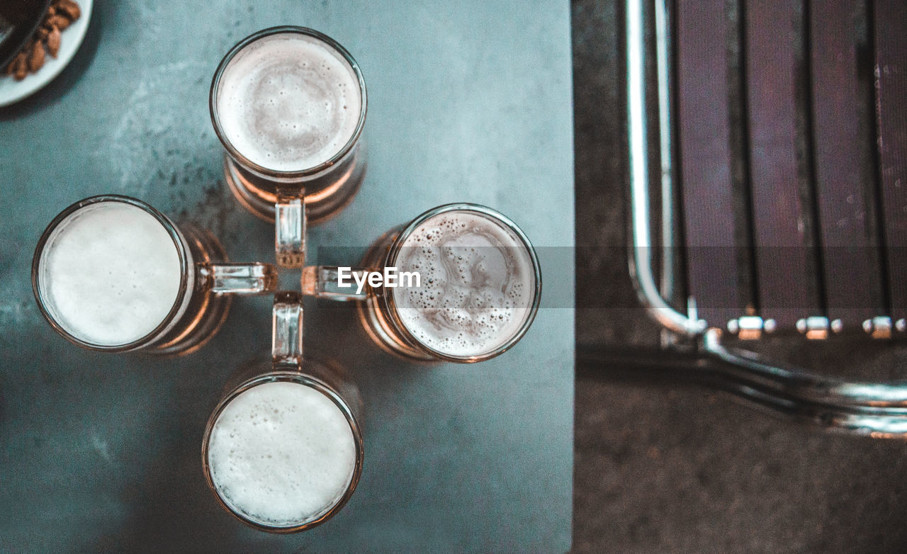 Close-up of beer glasses on table