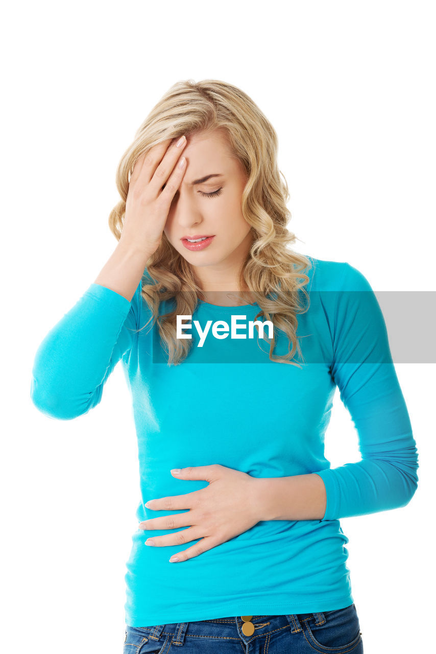 Woman with head in hand against white background