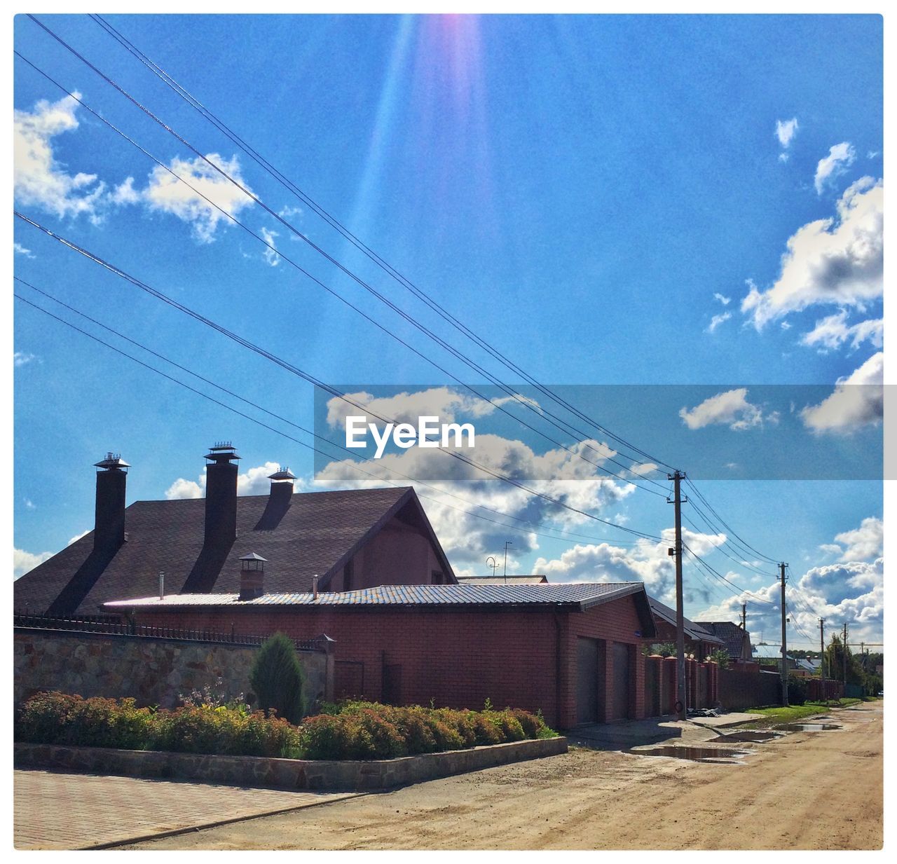 Houses against sky on sunny day