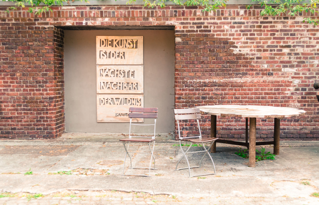 SIGN ON BRICK WALL