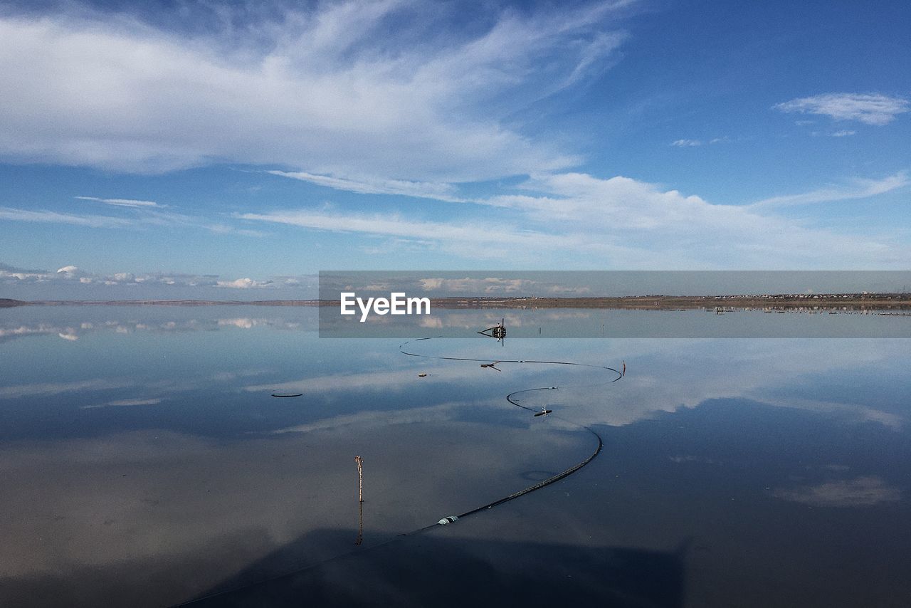 water, reflection, horizon, sky, cloud, sea, nature, scenics - nature, morning, beauty in nature, dawn, environment, tranquility, ocean, landscape, tranquil scene, no people, shore, blue, day, outdoors, travel, travel destinations, land, animal, coast, sunlight, animal themes, body of water, lagoon, beach, sunrise, animal wildlife, non-urban scene