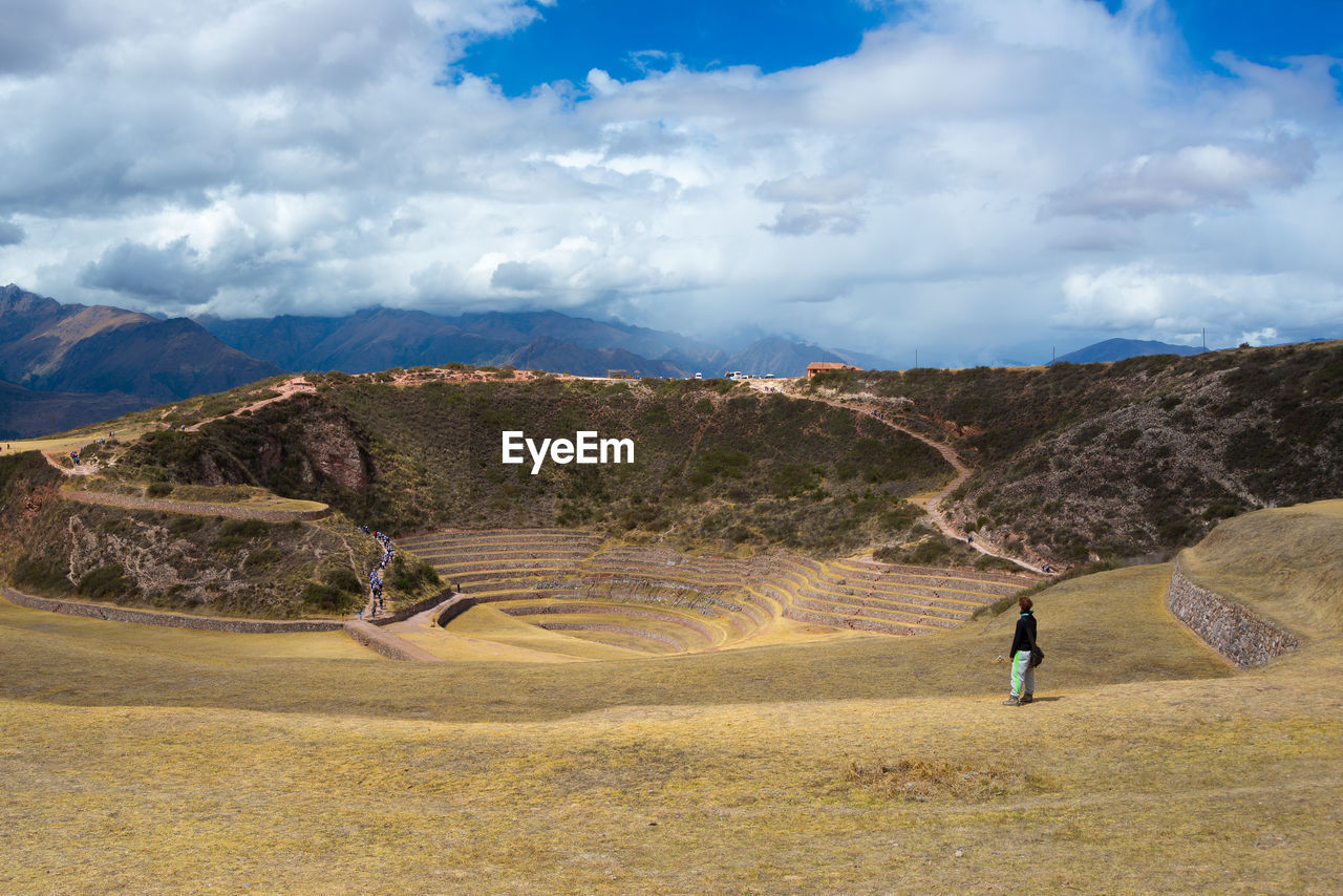 Woman standing on mountain against sky