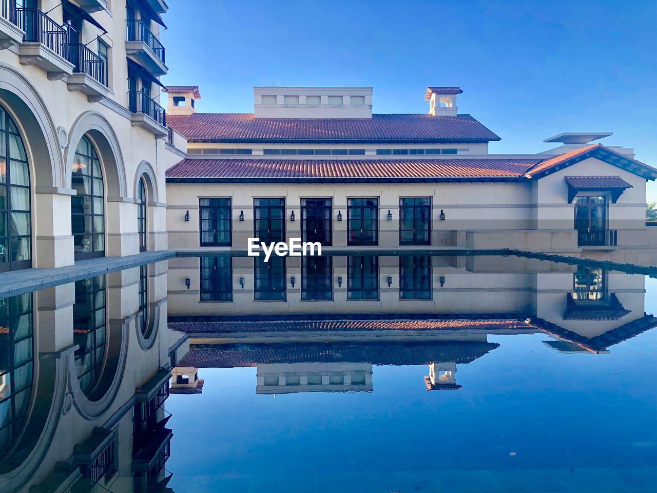 REFLECTION OF BUILDINGS IN SWIMMING POOL