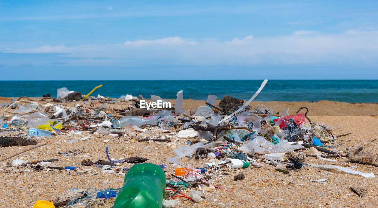 GARBAGE ON SAND AT BEACH