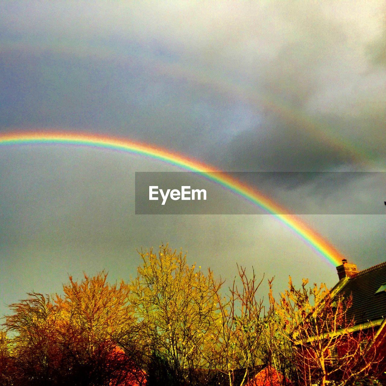 RAINBOW OVER CLOUDY SKY