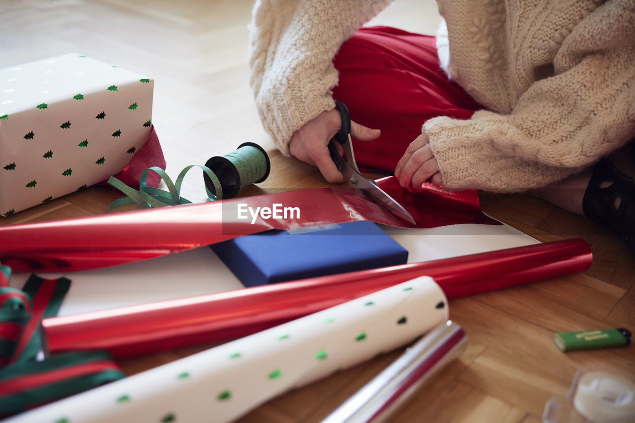 Woman's hands packing christmas presents