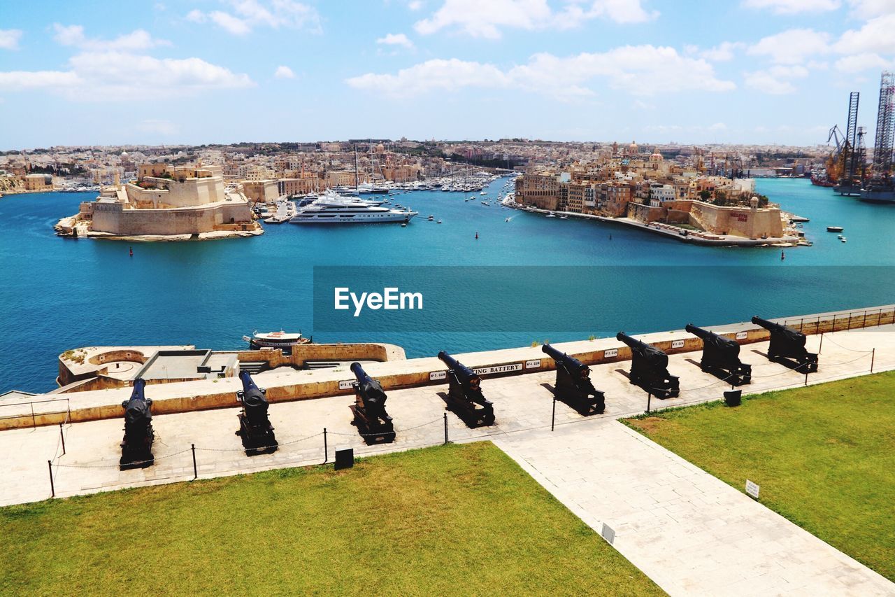 High angle view of boats in sea against buildings