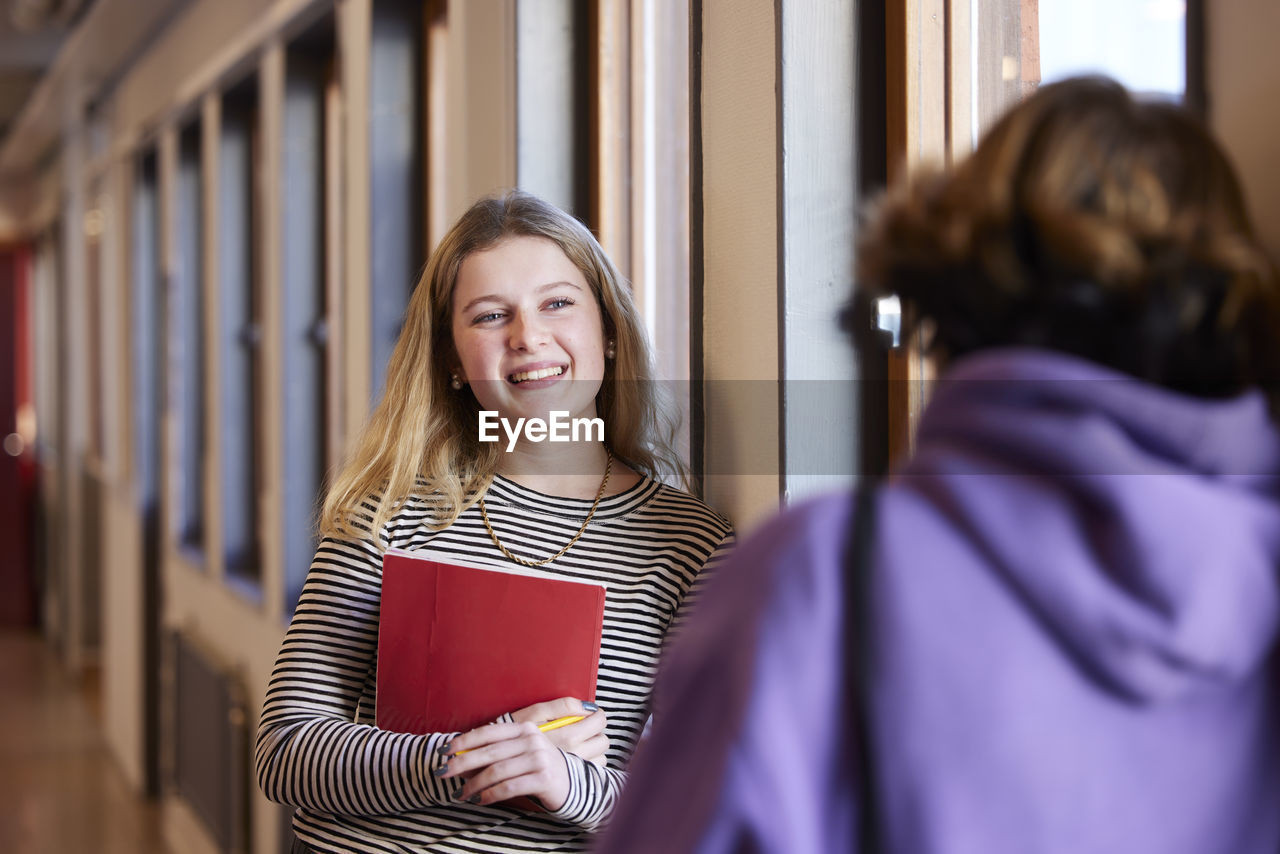 Teenage girls talking at corridor