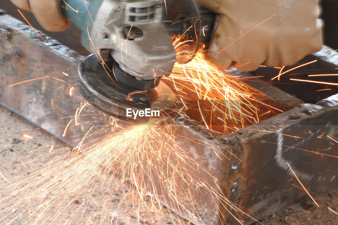 Man welding metal in workshop