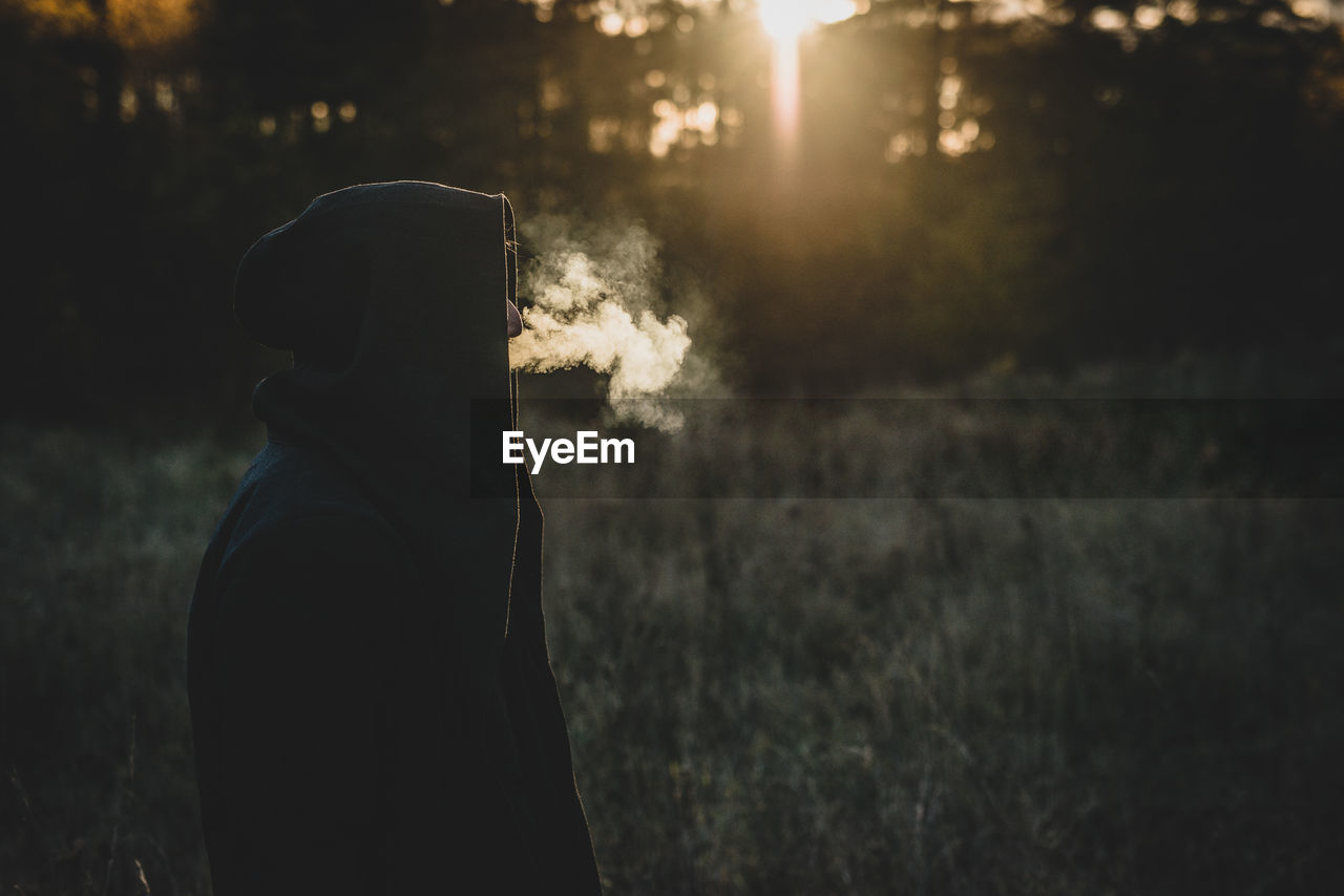 Silhouette person standing on field