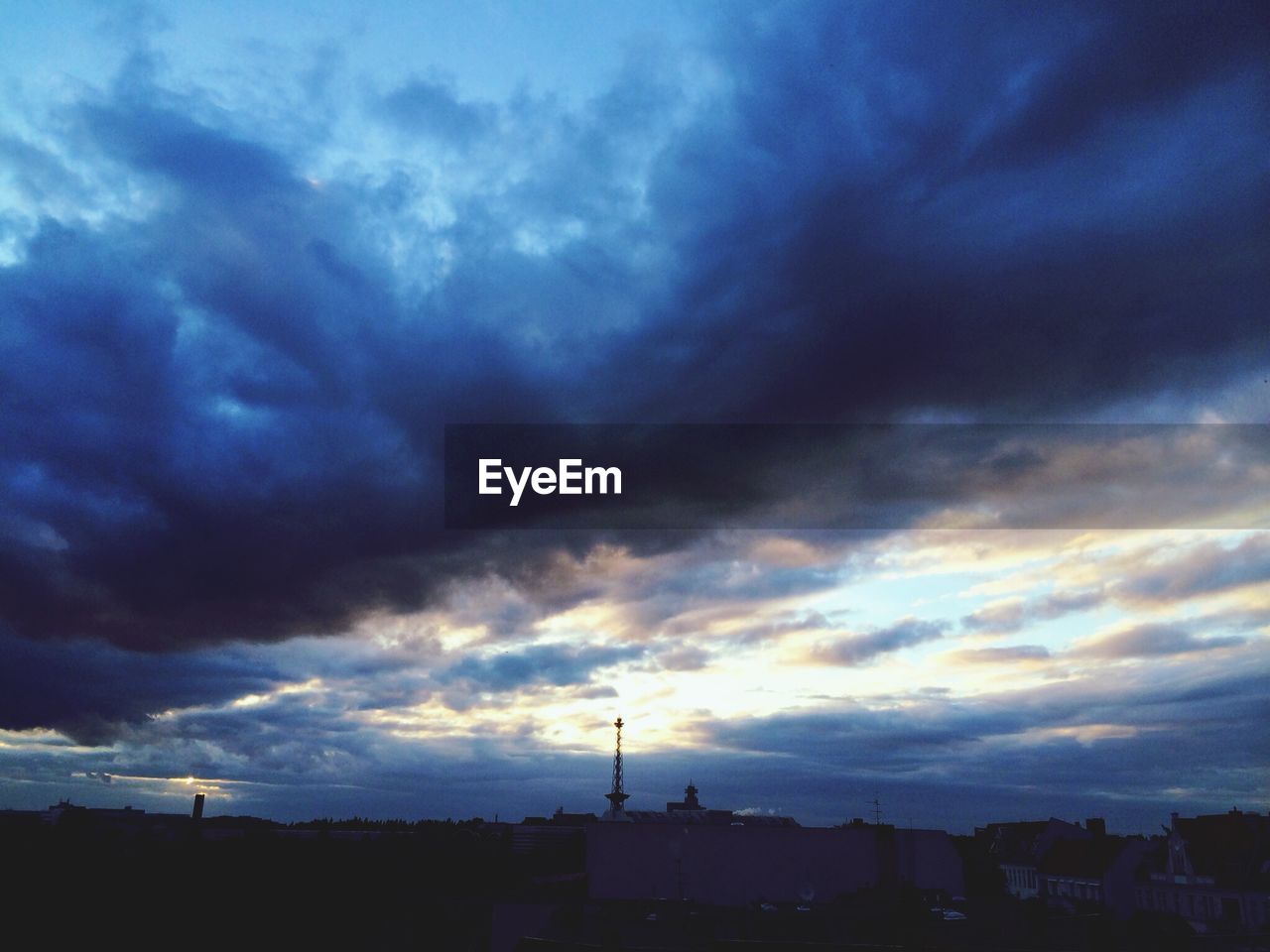 LOW ANGLE VIEW OF POWER LINES AGAINST CLOUDY SKY